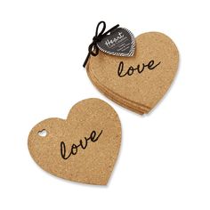 two heart shaped cork coasters with the word love written on them