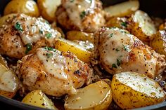 chicken and potatoes in a skillet with grated parmesan cheese on top