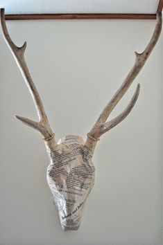 a deer's head made out of newspaper paper