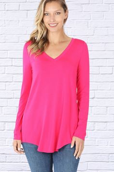 Looking for a top that is both stylish and comfortable? Look no further than the hot pink luxe rayon long sleeve v neck hi low hem top! This top is made from a soft and luxurious fabric that feels amazing against the skin. The fit is flattering and figure-skimming, and the v-neckline is both feminine and chic. The hi low hemline adds a touch of drama, and the long sleeves make this top perfect for cooler days. Dress up the luxe rayon long sleeve v neck hi low hem top with a statement necklace an Smart Casual Wear, Jeans And Flats, Basic Long Sleeve, Swimsuit Set, Judy Blue Jeans, Hem Top, Kids Swimwear, Plus Size Top, Unique Outfits