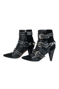 Unleash your inner rocker chick in these over-the-top booties from Isabel Marant. Buckles with grommets and studs adorn these edgy boots. Perfect for your next concert! Pair with distressed jeans and a leather jacket and you'll be sure to be invited on stage! Size 5.5 (FR 37) Leather upper w/ suede trim Buckled design w/ grommets and studs Interior side zipper closure Pointed toe Chunky heel Leather sole and footbed w/ very minor wear Heel 3.5" Leather Boots With Rivets For Concert, Leather Rivet Boots For Concert, Leather Studded Boots For Concert, Rocker Leather Boots With Studs, Leather Rocker Boots With Studs, Edgy Studded Boots For Concerts, Studded Boots For Concerts In Fall, Black Studded Moto Boots For Concert, Rocker Boots With Spikes For Fall