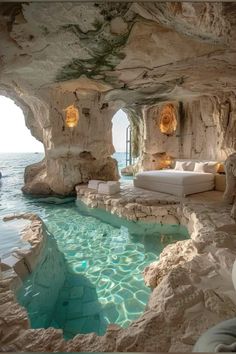 an indoor swimming pool in the middle of some rocks