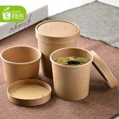 there are three cups and two plates on the floor next to each other, one with soup in it