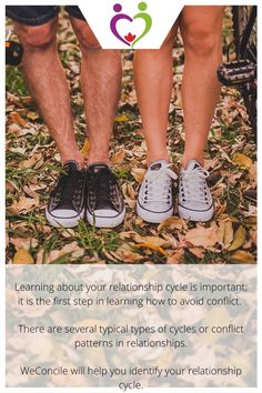 two people standing next to each other with their feet on the ground covered in leaves