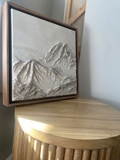 a wooden table with a painting on it