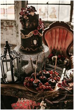 a three tiered cake sitting on top of a table next to other desserts