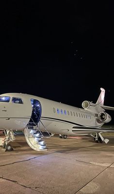 an airplane is parked on the tarmac at night with a message written above it that reads, here we go