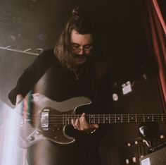 a man playing an electric guitar on stage