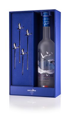 a bottle of vodka in a blue box with three birds on the top of it