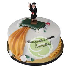 a cake decorated with an image of a man on top of a graduation cap and gown