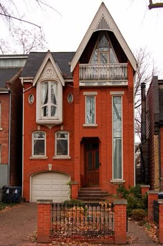 a red brick house with white trim and windows