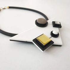 "Inspired by famous Piet Mondrian work, this is my interpretention of it. A monochromatic tones as opposed to Mondrian use of primary ones. Definitely a necklace for a stylish modern women! Lightweight necklace. * * * * * * * * * * * Materials: 0.24\"/6m\"m thick black silicon cord 0.12\"/3m\"m thick plexiglass resin acrylic colors Bib measurments: width: 4.7\"/12c\"m hight: 2.95\"/7.5c\"m maximum thicknes: 0.55\"/14m\"m Like wearing a set? check out shop's Clip On Earrings section: https://www. Resin Acrylic, Gold Statement Necklace, Bib Necklaces, Piet Mondrian, Geometric Necklace, Geometric Jewelry, Modern Women, Black Necklace, Bib Necklace