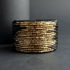 Wide black & gold beaded cuff bracelet. Statement big | Etsy Unique Gold Beaded Cuff Bracelet, Gold Beaded Bangle Cuff Bracelet, Bohemian Gold Cuff Bracelet With Round Beads, Handmade Elegant Beaded Bracelets, Gold Bohemian Cuff Bracelet With Round Beads, Handmade Round Beads Cuff Bracelet For Party, Handmade Round Bead Cuff Bracelet For Party, Handmade Party Cuff Bracelet With Round Beads, Gold Bangle With Round Beads For Party