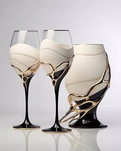 three wine glasses sitting next to each other