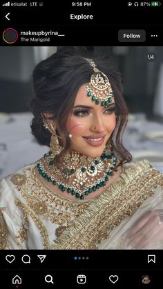 a woman in a bridal outfit with jewels on her head and jewelry around her neck