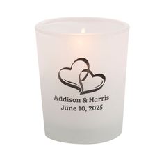 a candle with two hearts on it and the words madison & harris written in black