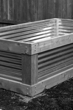 a wooden bed sitting in the middle of a yard next to a fence and grass