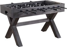 the foosball table is made out of wood and has four legs that are connected to each other