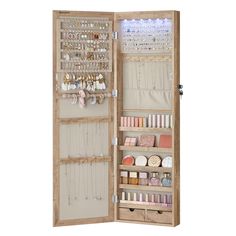 an open wooden jewelry cabinet filled with lots of items