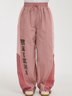 These are WAIKEI's unique nylon racing pants detailed with trendy logo embroidery, color-blocking panels and piping for casual mood. They're finished with drawstring to adjust silhouette for versatile styling.   - Elasticated drawstring waistband- Two front welt pockets- Two back welt pockets- Logo embroidery- Color-blocking- Adjustable drawcord at hem- Wide fit- Unisex wear Sporty Pants With Contrast Stitching For Streetwear, Sporty Bottoms With Contrast Stitching For Streetwear, Sporty Pink Nylon Pants, Sporty Parachute Pants With Drawstring, Sporty Parachute Pants With Reflective Details For Streetwear, Joggers Outfit Women, Racing Track, Trendy Logos, Joggers Outfit