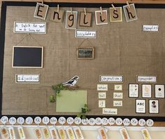 a bulletin board with words and pictures hanging on it's side, along with magnets