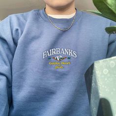 "*SIZES ARE UNISEX* -For women, I'd suggest your usual size for a regular fit (size up for a more relaxed fit). Men should size up for a more relaxed fit. *these sweatshirts are extra comfy when oversized ⛰ \"Fairbanks Golden Heart of Alaska\" embroidered with on a comfy cute vintage-style crewneck. A sturdy and warm sweatshirt bound to keep you warm in the colder months. A pre-shrunk, classic fit sweater that's made with air-jet spun yarn for a soft feel and reduced pilling. Your new favorite s Cheap Vintage Women's Sweatshirt, Cheap Embroidered Sweater For Streetwear, Affordable Throwback Crew Neck Tops, Cheap Vintage Crew Neck Hoodie, Cheap Retro Long Sleeve Sweatshirt, Cheap Retro Crew Sweatshirt, Cheap Vintage Style Sweatshirt For Fans, Cheap Crew Neck Fan Merchandise Top, Cheap Throwback Style Crew Neck Sweatshirt