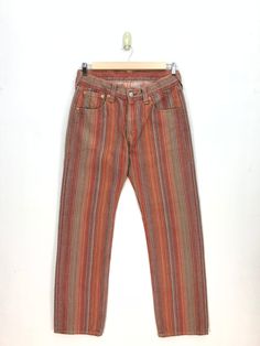 Vintage Levis Jeans Red Stripe Levis 501 Denim Pants - BS47597.  Manual Measurement (laying in flat area):  1) Waist: 34 inch.  2) Rise: 10.5 inch.  3) Hips: 22.5 inch.  4) Tight: 12 inch.  5) Outseam: 44 inch.  6) Inseam: 33 inch.  7) Leg opening: 9 inch.  Made in: JAPAN.  Fabric Material: 100% Denim Cotton.  Condition: In good vintage condition overall.  Please check all the measurement to insyre a proper fit.  Remember to allow yourself some extra room for movement.  You can compare these information with your favourite pants too.  BS47597.  We do combining shipping.  Please Read Before Purchase. Drop your phone number. Tracking number can be tracked 3 - 5 days after shipment process. Please be patient waiting. This design and style by wearing it increases your confidence. All pieces ar Vintage Baggy Straight Leg Jeans, Casual Multicolor Full-length Jeans, Multicolor Full-length Jeans With Pockets, 90s Relaxed Fit Bottoms With Five Pockets, Multicolor Full Length Jeans For Fall, Multicolor Straight Leg Bottoms For Streetwear, Vintage Baggy Pants With Five Pockets, Retro Relaxed Fit Faded Bottoms, Brown Straight Leg Jeans For Summer