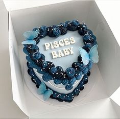 a heart shaped cake in a box with the words pisces baby written on it