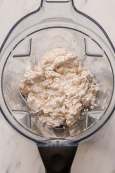 a blender filled with cream on top of a white counter