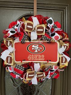 the wreath is decorated with footballs and other sports related items, such as an ornament