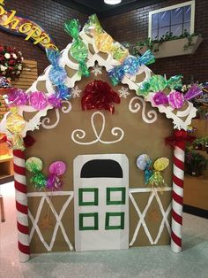 a gingerbread house decorated with candy canes and decorations