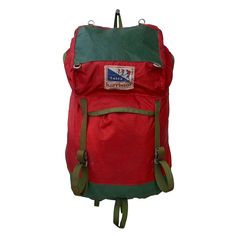 a red backpack with green straps on it