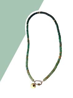 22 inches of dark green genuine agate rondelles in ombre order with a gold toned screw closure doubling as security and the centerpiece of the necklace. From the screw closure hangs a gold toned disc and tiny plum rhinestone. This boho style necklace is strung on 7 strand braided stainless steel wire with nylon coating for extra strength. Features brass and iron hardware.  Add this to your own custom stack or browse my shop to create one from scratch (or wear it alone!). Thanks for supporting my small business!