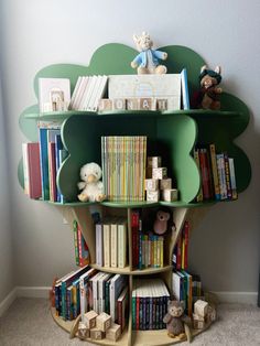 a bookshelf filled with lots of books next to a stuffed animal and teddy bear