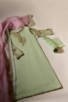 Turn heads in " Azaa " like its name, Azaa is a vision to behold, rendered on pistachio green pure organza with delicate handwork details, paired with heavy teapink pure dupatta organza dupatta and matching raw silk trousers. The length of the kameez is 45 inches. Delivery Time: 4 to 8 Weeks Luxury Raw Silk Dress With Dabka Work, Luxury Pista Green Salwar Kameez With Dabka, Luxury Pista Green Traditional Wear With Dabka Work, Cheap Zari Work Dupatta For Eid, Luxury Unstitched Silk Suit With Dabka Work, Cheap Traditional Dupatta With Zari Work, Luxury Light Green Dupatta With Resham Embroidery, Luxury Organza Churidar With Dabka Work, Luxury Georgette Dupatta For Eid