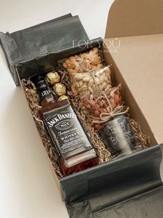 an open gift box with liquor and condiments