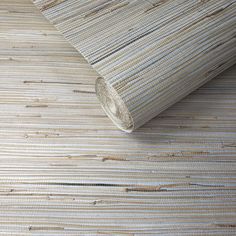 a close up view of a bamboo wallpaper with an area rug on the floor