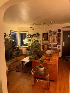 a living room filled with furniture and lots of plants