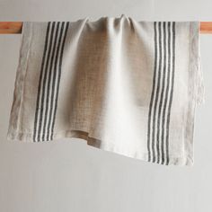 a black and white striped towel hanging on a clothes line