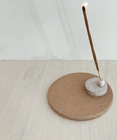 a small white object with a wooden stick sticking out of it's center piece