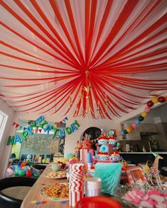 a party with red and white decorations on the ceiling