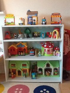 a white book shelf filled with lots of toys