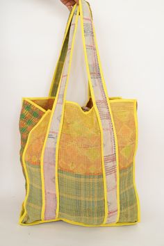 This bag is made from a vintage hand-stitched Kantha quilt. We make only 1-2 bags from each quilt and every one of them is one of a kind! Details: Shell fabric- Vintage quilted cotton Kantha 1. width (cm) - 35 2. height (cm)- 45 3. depth (cm) - 35 4. weight (g)- 0.400 kg 5. length of shoulder (cm) -25 cm Care instructions: Dry clean or Hand-wash in warm water. Drip dry. How it's made: Kantha quilts are made using numerous layers of recycled silk or cotton saris which are hand-stitched in the tra Green Quilted Square Bag, Square Green Quilted Bag, Green Patchwork Shoulder Bag For Travel, Vintage Green Square Bag, Vintage Square Green Bag, Bohemian Yellow Square Bag, Yellow Square Bohemian Bag, Green Patchwork Tote Shoulder Bag, Green Quilted Shopping Bag