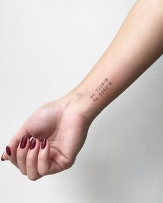 a woman's arm with a small tattoo on the left side of her hand