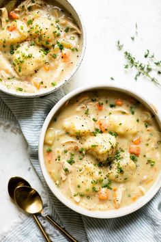 two bowls filled with soup on top of a table