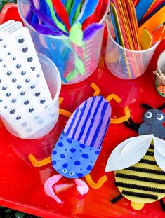 a red tray topped with lots of craft supplies