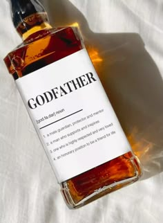 a bottle of godeather sitting on top of a white sheet covered tablecloth