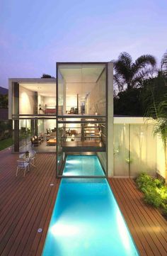 an indoor swimming pool in the middle of a wooden deck