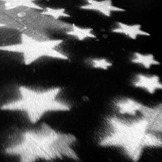 black and white photograph of stars on the ground