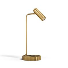 a gold desk lamp on a white background with the light turned on and one arm extended